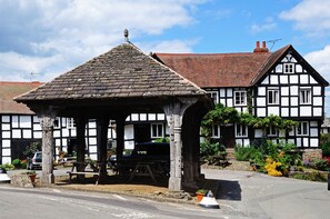 A traditional half-timbered building with a covered outdoor seating area.