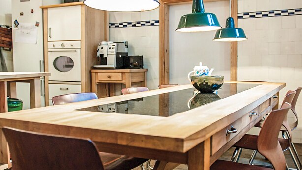 A kitchen with a wooden table, chairs, and pendant lights. - Lovely home in Wolin with WiFi (Wolin)