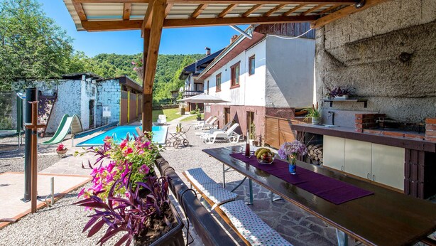 A covered outdoor area with a pool, lounge chairs, and a barbecue grill. - Beautiful home in Plaski (Plaski)