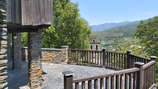 A stone patio with a wooden fence overlooking a mountainous landscape. - The Balcony of Sotillo. Near Las Médulas (Sotillo de Cabrera)
