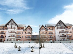 A snow-covered building with multiple balconies and a clear sky. - Apartment in Valmeinier with Valley Views (Valmeinier)