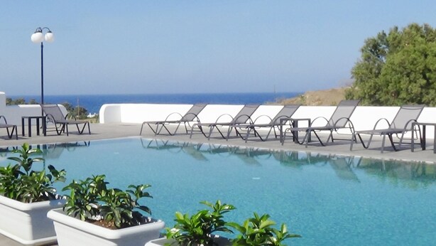 A pool area with lounge chairs and potted plants. - 3 bedroom Luxury villa , 200m by  famous Monolithos  beach!  (Έξω Γιαλός Καρτεραδου)