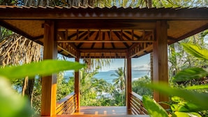 A wooden gazebo with a view of the ocean and palm trees. - Cliff House with Private Infinity Pool. 3 Minute Walk to the Beach. (Puntarenas)