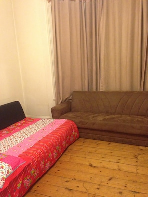 Cozy retreat with a comfortable bed and a stylish sofa.