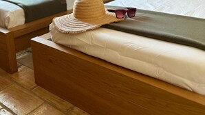 A double bed with a straw hat and sunglasses on it, a green pillow, and a wooden headboard. -  Portugal Private Villa with private pool rural quiet tranquil setting (moncaropacho)