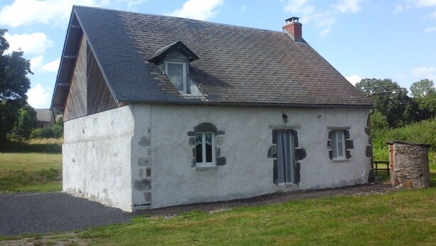 A single-story house with a sloped roof, a chimney, and a small porch area. - $ ATYPICAL COUNTRY HOUSE (Sauvagnat)