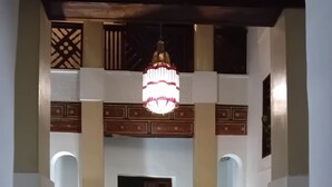 A lobby with a chandelier, seating area, and decorative plants. - Beau Riad for Rent (Fès-Boulmane)