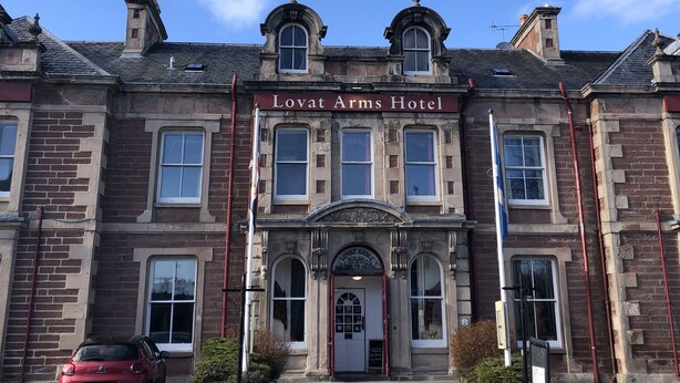 A historic building with a prominent sign reading "Lovat Arms Hotel." - Traditional highland cottage with magnificent panoramic views  (invernesshire)