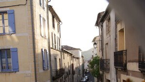 A narrow street lined with buildings, some with balconies and shutters. - Secluded Villa With Private Pool (Lodève)