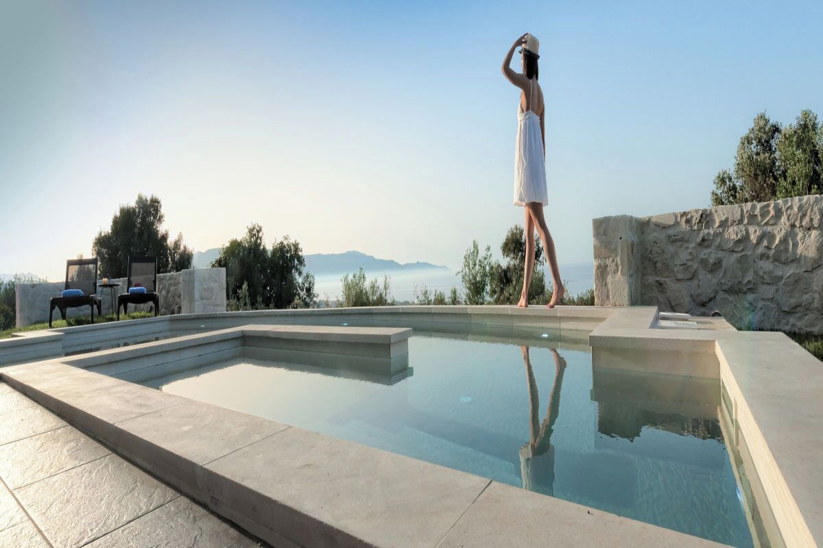 A heated pool, sun loungers