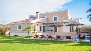 A two-story stone house with a swimming pool, outdoor seating, and a well-maintained lawn. - Orange Tree Garden Villa (Chania)
