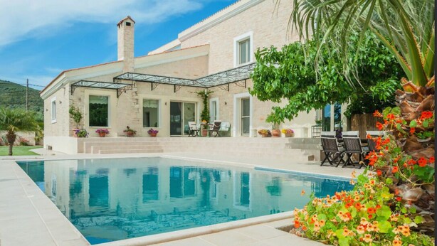 A house with a swimming pool, outdoor seating, and a garden. - Orange Tree Garden Villa (Chania)