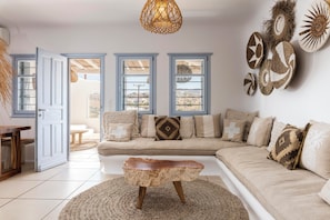 A living room with a sofa, coffee table, and decorative wall art.
