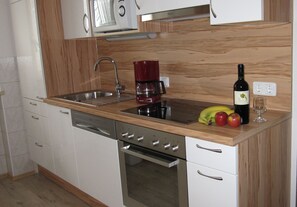 Enjoy cooking in this well-equipped kitchen with a stainless steel sink, coffee maker, and oven.