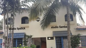 A two-story building with a sign reading "studio Samba" on the upper floor.