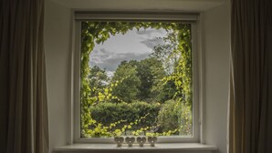 A window with a view of a garden. - 18th Century Mill House in a Courtyard Setting (.)