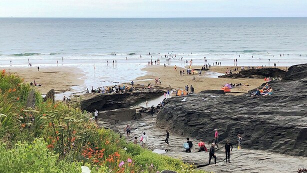A beach with rocky terrain and people engaging in various activities. - 4 bedroom accommodation in Delabole, near Tintagel (Delabole, near Tintagel)