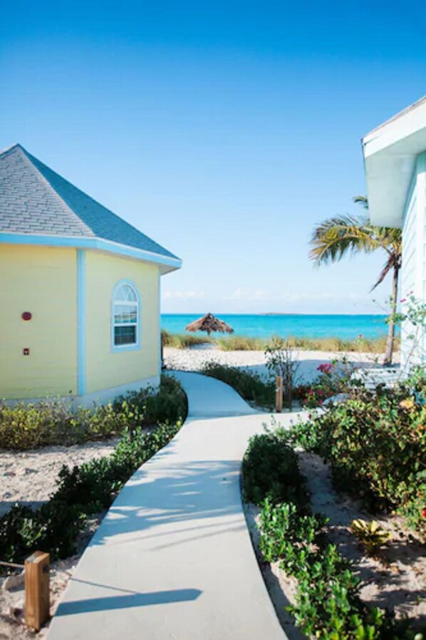 A pathway leading to a beach house with a clear view of the ocean. - Paradise Bay (Rokers Point)