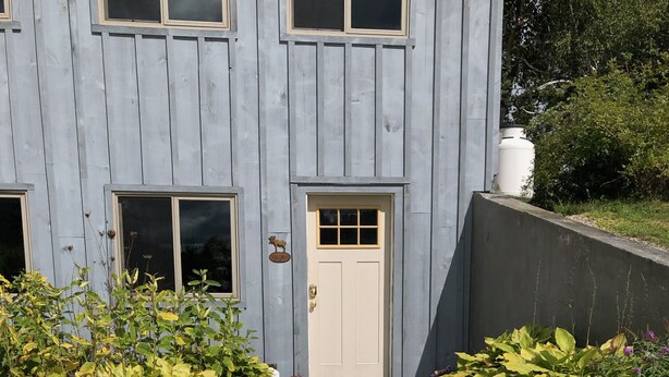 A building with a stone pathway leading to a door.