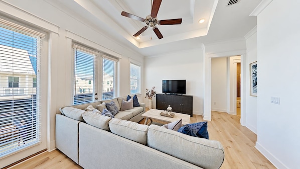 A modern living room with a sofa, coffee table, and TV.
