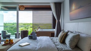 A modern hotel room with a large bed, a bedside table, a window with blinds, a view of greenery, and a painting on the wall. - Solmare Apartments & Suites (Akumal)