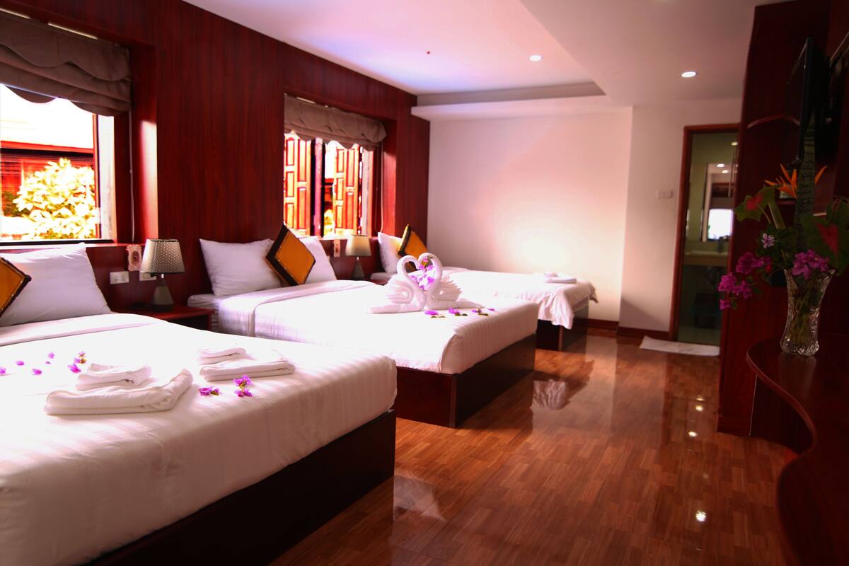 Deluxe Quadruple Room | Minibar, in-room safe, desk, laptop workspace