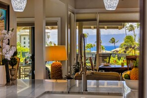 A hotel lobby with a view of palm trees and the ocean. - Molokai views, refreshed upgrades, relax comfort (Lahaina)