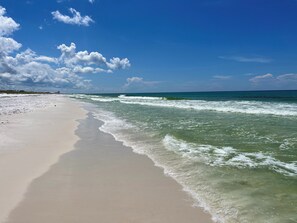 A beach with clear skies and gentle waves.