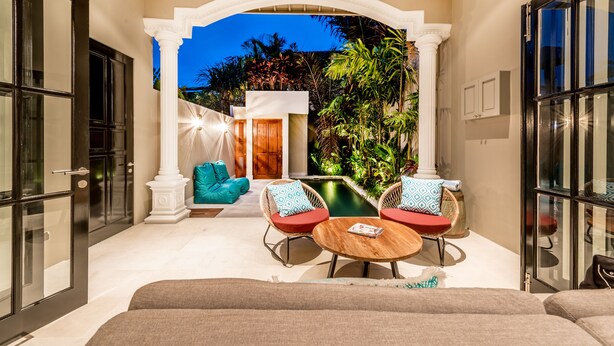 A spacious outdoor area with a pool, seating, and a view of the sky. - Central 1 Bedroom Villa 5 min walk to Seminyak Beach (Seminyak)