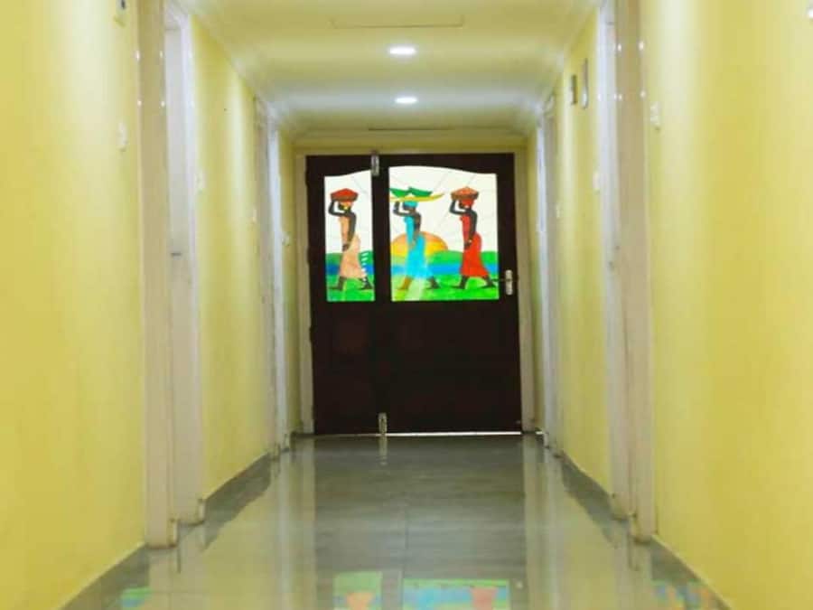 A hallway with a double door featuring colorful artwork.
