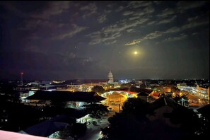 A nighttime cityscape with illuminated buildings and a prominent tower in the distance. - Bergamo Hotel Lingayen (Lingayen)