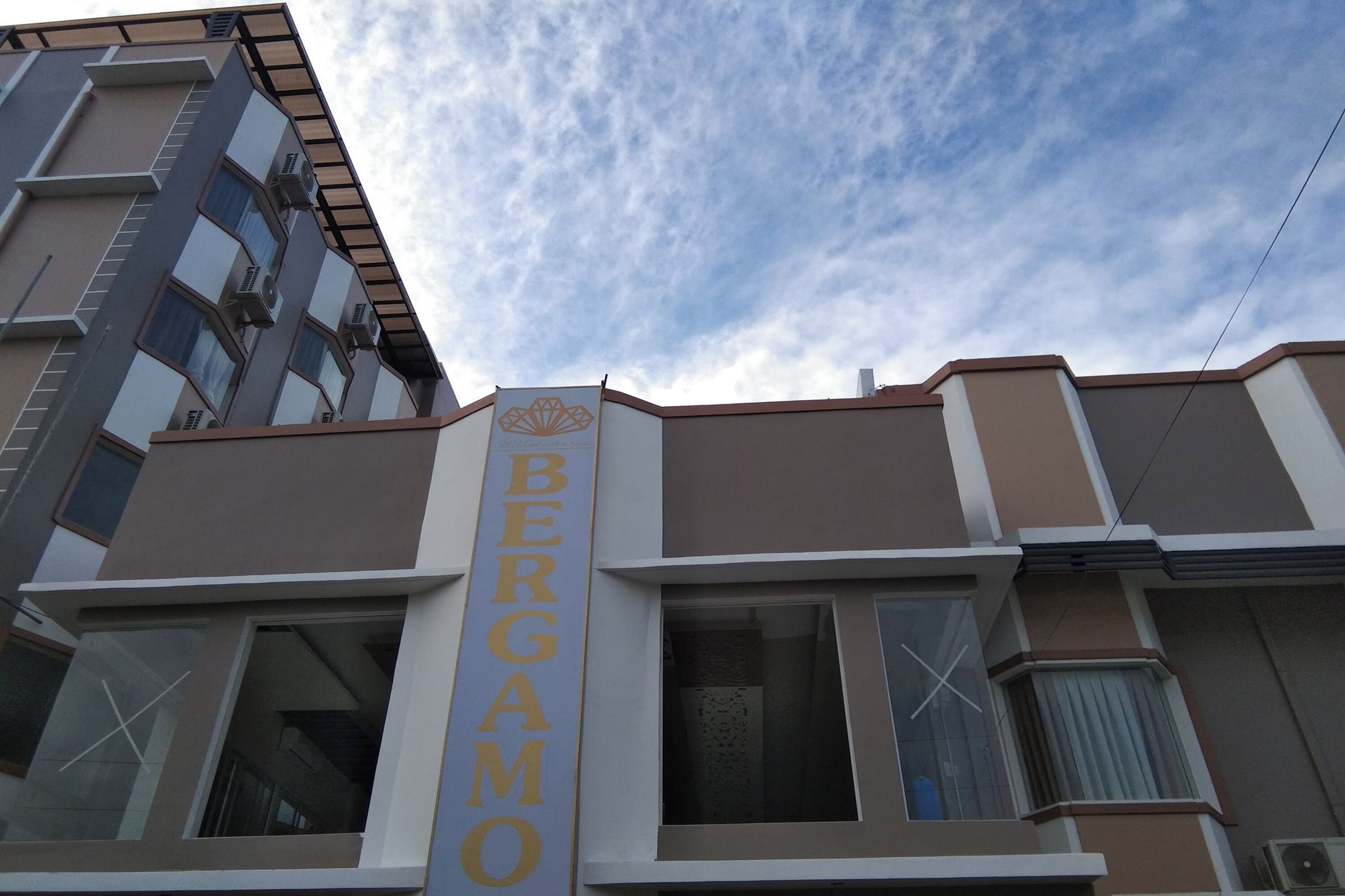 A building with a prominent vertical sign reading "BERGAMO".