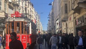A tram on a city street with pedestrians. - Taksim Palace İstanbul Hotel (Istanbul)