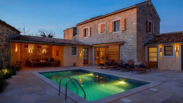 A stone building with a swimming pool, outdoor seating, and a well-lit patio area. - Beautifully Renovated Traditional Stone Villa, Private Pool in the Picturesque Village of Sisan! (Sisan)
