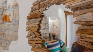 A rustic stone wall with a wooden frame structure. - Beautifully Renovated Traditional Stone Villa, Private Pool in the Picturesque Village of Sisan! (Sisan)