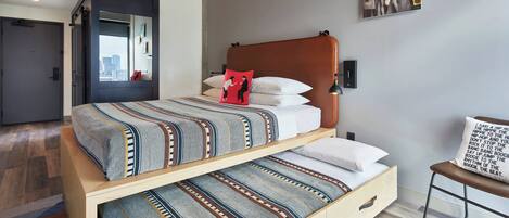A modern bedroom with a bed, a mirror, and a chair.