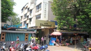 A multi-story building with a sign for 'Hotel Diamond' and a restaurant named 'Rangoli'. - Hotel Diamond (Mumbai)