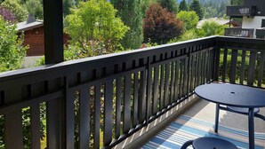 A balcony with a view of mountains and trees.