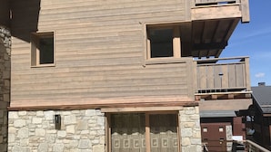A two-story building with a stone facade and wooden balconies.