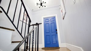 A staircase with black railings leading to a blue door. - Modern 3BR/ Close to Encore- Everett #2 (Everett)