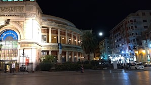 A historic building with classical architecture, featuring columns and a large arched entrance. - Il Genio del Porto - Mabbonath b&b (Palermo)
