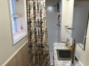 Combined shower/bathtub, hair dryer, towels, soap