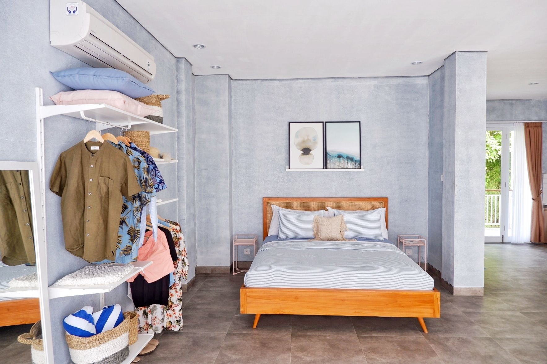 A bedroom with a bed, a wardrobe, and an air conditioning unit.