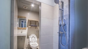 A modern bathroom with a shower, toilet, and sink. - 202 # Best studio apartment at Ubud Center (Ubud)