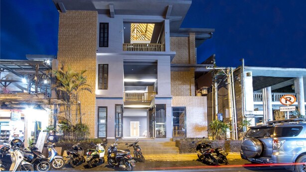 A multi-story building with a modern design, featuring a prominent entrance and a balcony. - 201 # 1BR Studio apartment in the center of Ubud (Ubud)