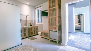 A modern bathroom with a wooden vanity, a large mirror, and a shower area. - 201 # 1BR Studio apartment in the center of Ubud (Ubud)