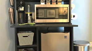 A kitchen area with a microwave, coffee maker, and storage baskets. - Relax in Your Own Private Suite in Charleston's James Island! (Charleston)