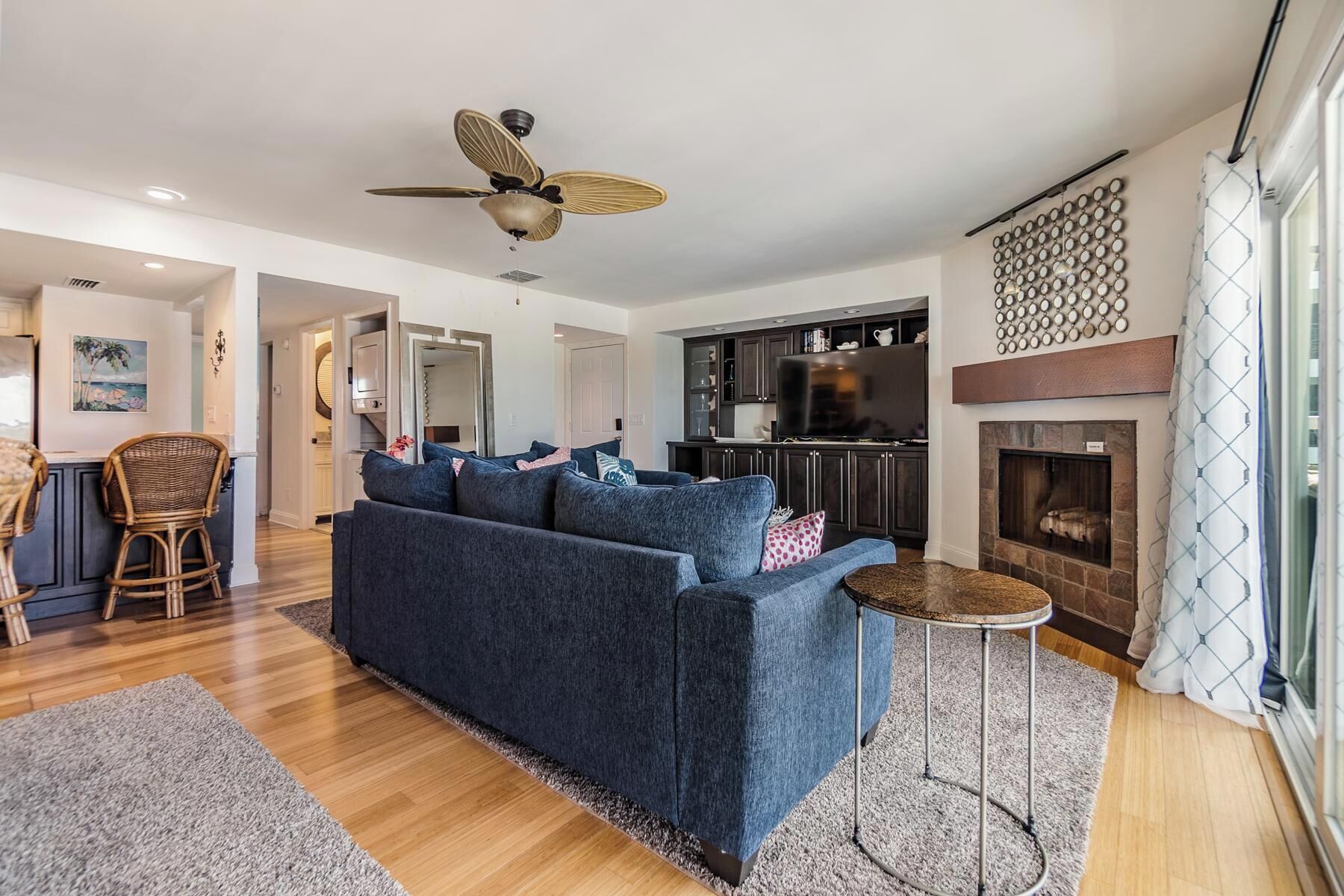 A modern living room with a sofa, a round coffee table, and a fireplace.