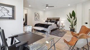 A modern hotel room with a bed, a desk, and a dining area. - Comfort in a Condo Gainey Ranch Style (Scottsdale)