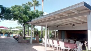 An outdoor patio area with a covered seating area, a pool, and palm trees. - Mapagog: CASA PIXAVI, Surrounded by orange trees between the mountains and the beach <br> (Castello)